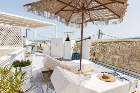 Two cosy sunbeds and a stylish umbrella