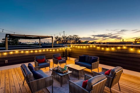 The rooftop terrace at golden hour with string lights and city views is the crown jewel of this home.