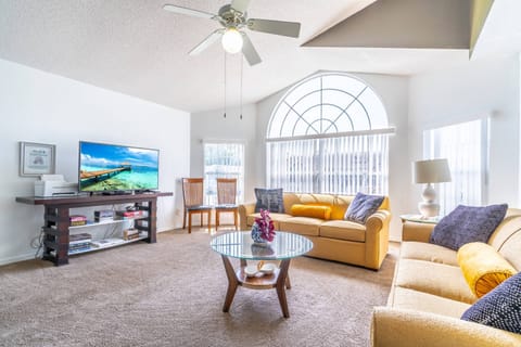 Open Concept Living and Dining room with tall, vaulted ceilings. Living Room features a pull out sofa bed.