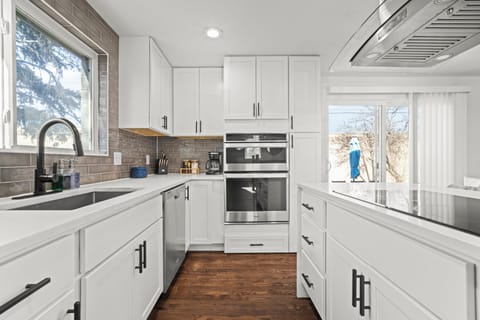Clean, sun-filled kitchen fully equipped for group cooking and effortless gatherings