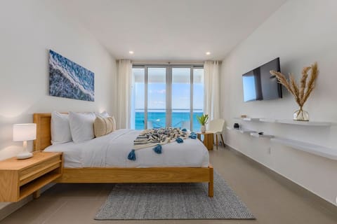Wake up to stunning ocean views from your serene bedroom retreat, where soothing coastal tones and modern comfort blend seamlessly to create your perfect beachside escape.