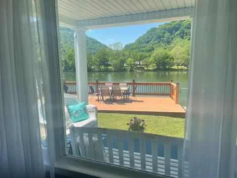 View of the yard, deck, river and mountains from the Livingroom. 