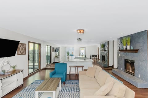 Terrace level bar has 5 stools, couch, and two chairs.