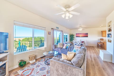 Living room with an open floor plan connecting the Dining Area and the Kitchen.