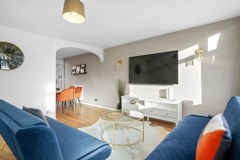 Unwind in the comfortable living room, featuring a 50” Smart TV, perfect for relaxing with your favourite shows after a long day.