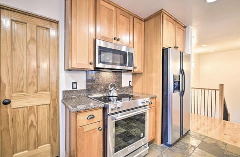 Kitchen fully stocked with dishware and cookware. Traditional drip coffee maker