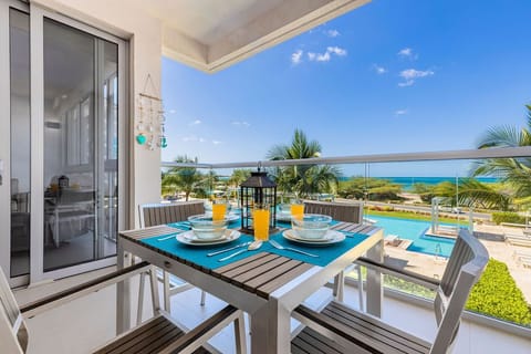 Sip morning juice on your private balcony while the ocean breeze brushes your face and palm trees frame stunning sea views perfect for unforgettable coastal dining.