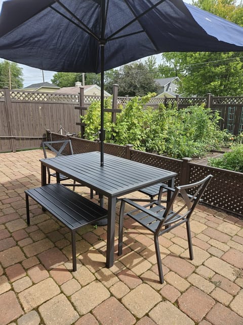 Relax on the back patio in the fully fenced in yard.