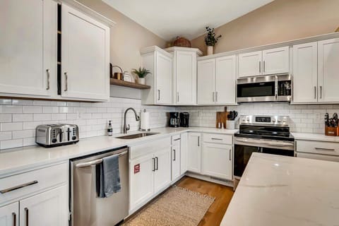 Stainless steel appliances and quartz countertops are a real treat in this kitchen!