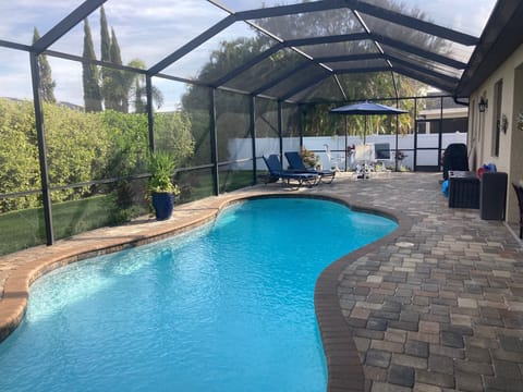 Pool area, table & chairs, lounges