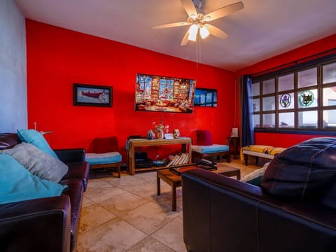 A modern living area featuring a large flat-screen TV mounted for optimal viewing, creating a perfect entertainment hub for relaxing after a day at the pool.