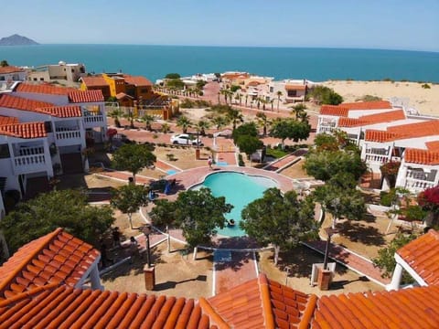 A stunning drone-captured overhead view showcasing La Hacienda Condo 6 along with the neighboring properties, highlighting the spacious layout and prime location within the community.