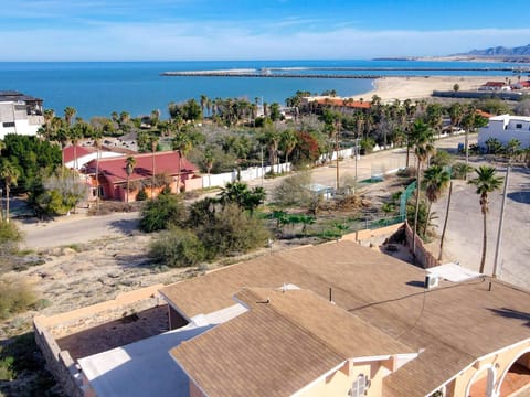 5-bedroom, 5-bath luxury home with two gourmet kitchens and a rooftop terrace with 360° ocean views .