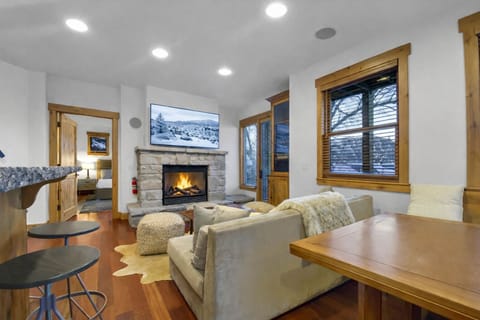 Cozy up in your mountain retreat with crackling fireplace and plush seating, perfect for après-ski relaxation.