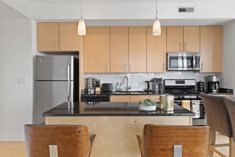 Fully stocked kitchen with all appliances, silverware, plates and dishes, spices