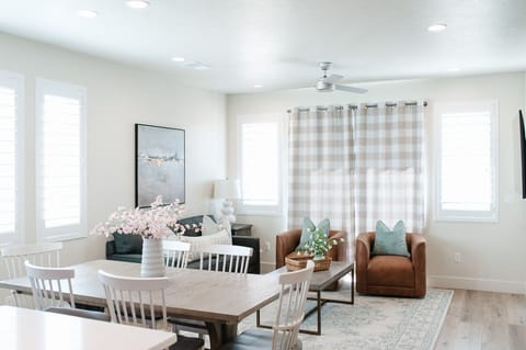 Bright and elegant dining space with natural light, comfortable seating, and a fresh open feel—perfect for meals, morning coffee, or relaxing between outings.