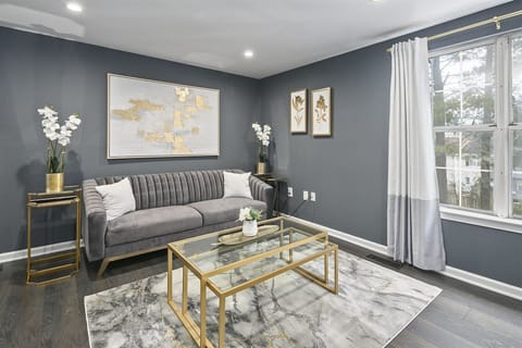 Relax in the living room`s upholstered, soft velvet sofa