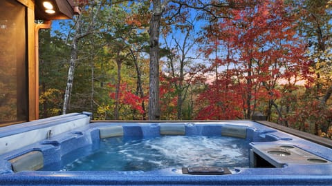 Relax in the hot tub with spectacular lake and mountain views
