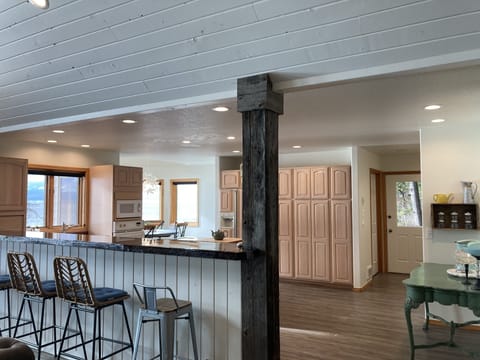 Long, tall bar countertop that is situated between the kitchen and great room. 