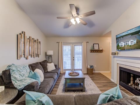 The classic French doors accentuate the charm and warmth of the living room as they invite you to step out onto the private balcony.