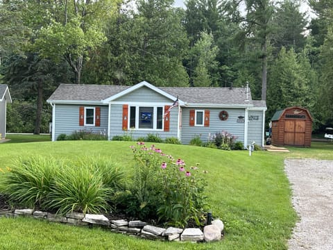 Street view of the cottage. My husband & I made the pine cut-out shutters.