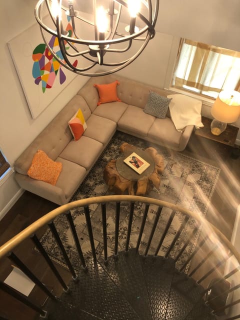 View from the top landing of the Spiral staircase of the Livingroom w/ 65" T.V.