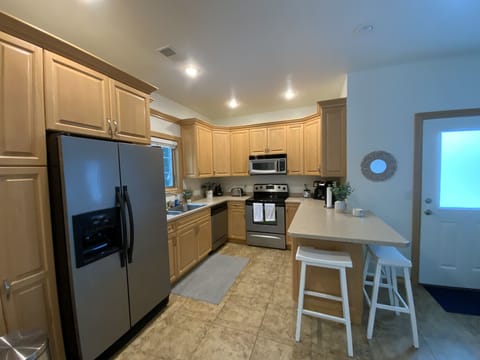 Kitchen equipped with all the necessities, including island seating