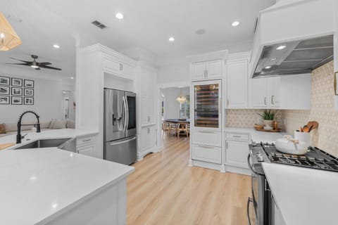 Gourmet kitchen with custom cabinetry & wine fridge