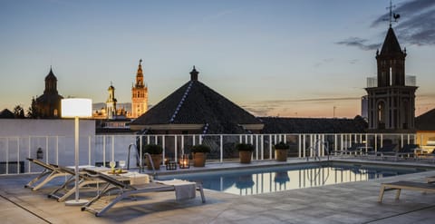 Seasonal outdoor pool, open noon to 9 PM, pool umbrellas, sun loungers