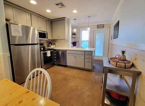 The kitchen features stainless appliances and a coffee bar.
