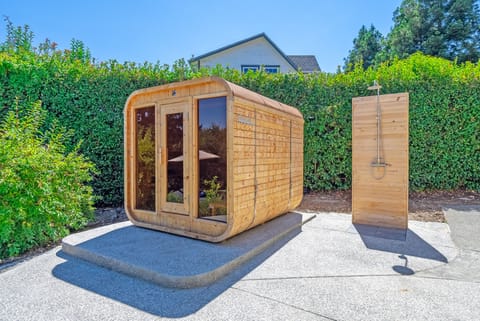 Outdoor pine wood sauna and outdoor shower