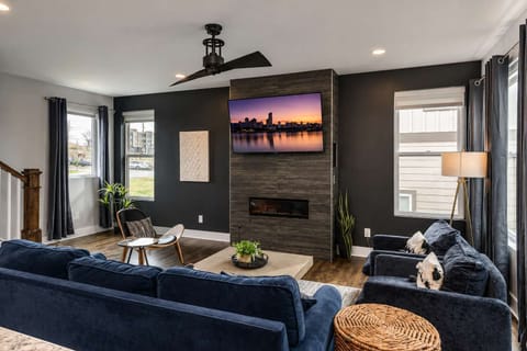 Bright, open-concept living area with stylish seating, warm wood accents, and abundant natural light for relaxing and gathering.