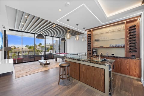 Elegant home bar area with built-in wine storage and city views