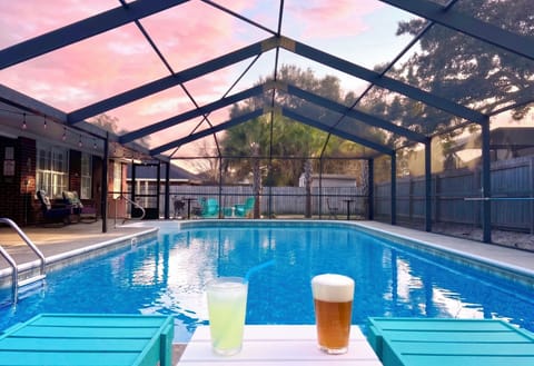 Relax and soak up the sunsets with a cold beverages in Polywood chaise lounges next to the gorgeous, screened-in, and the heated (year round) pool. Cheers!!