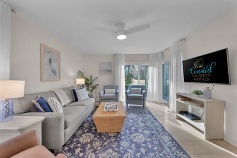 Living room  features a queen sized sleeper sofa and a tv
