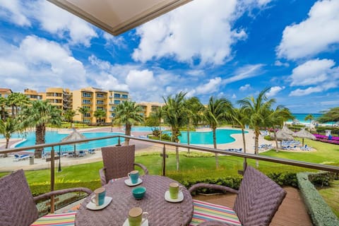 Wake up with this pleasant view of the pool and garden from your balcony.