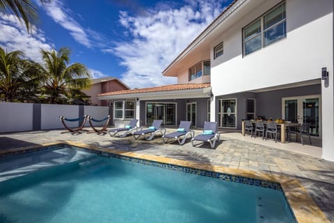 This villa is gleaming with this relaxing private pool. The pool area has an abundant sun lounger and outdoor chairs.
