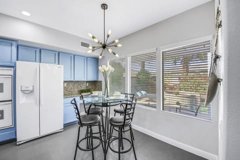 The casual bistro-style table features seating for four/