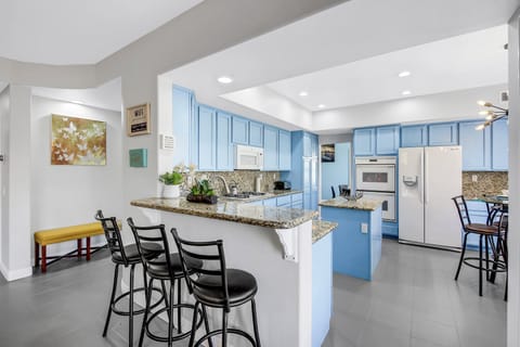 Watch the family chef from the bar height dining with seating for three.