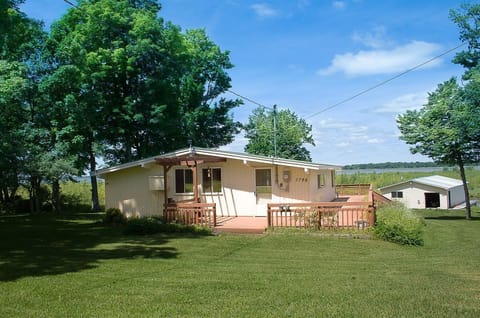 View of the cottage from the lane with boathouse below 