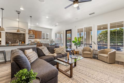 The open concept living room, dining room, and kitchen will make it easy for your group to be together