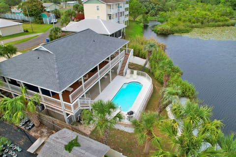 Stunning waterfront property featuring private pool and lake access in peaceful tropical setting.