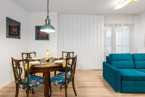A wooden dining table set with chic chairs, perfect for shared meals.