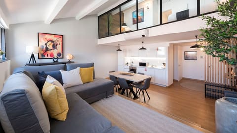 A spacious living area featuring a large, comfortable sofa and a fully equipped kitchenette — perfect for relaxing and effortless home dining.

#ModernLiving #OpenSpace #ComfortInStyle #PortugalStay