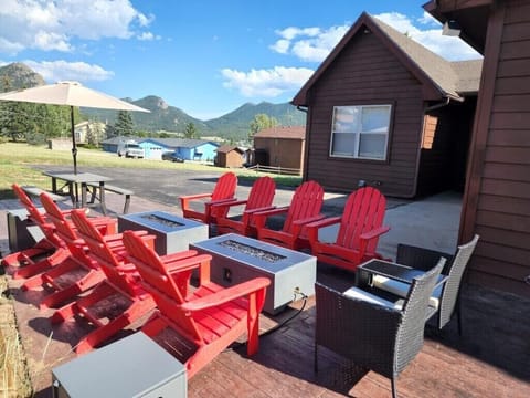 2 x 4 ft Fire tables surrounded by 8 Adirondack chairs. picnic table w/ shade