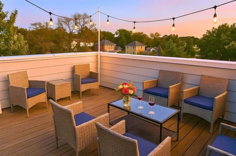 Sip wine under string lights on the rooftop terrace at dusk.