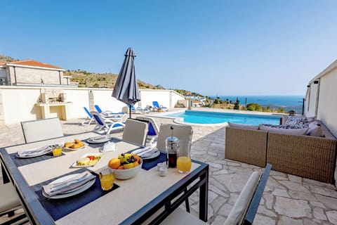 A large stone topped dining table, invites you and your guests to dine alfresco 