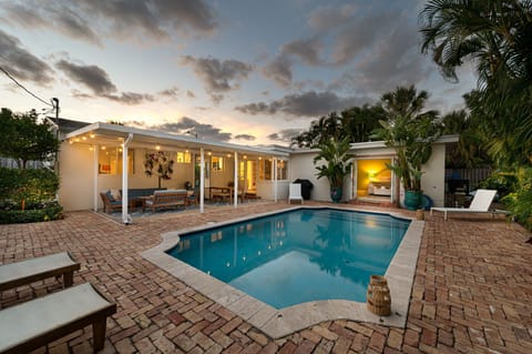 Indulge in a tropical retreat as you step onto the private pool deck, complete with sun loungers, an outdoor dining area, and a relaxation zone. The covered patio boasts a grand outdoor mirror and a captivating orchid wall display, adding to the allure.