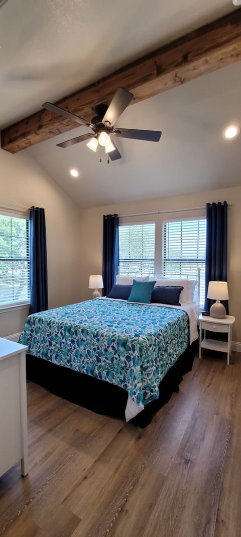 Bedroom 1 with cathedral ceilings and wood beams.
