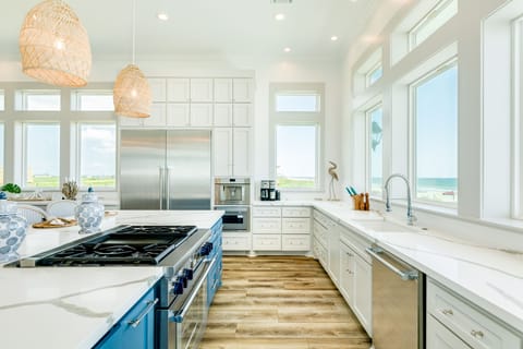 Kitchen with stainless steel appliances including a full size side-by-side refrigerator
